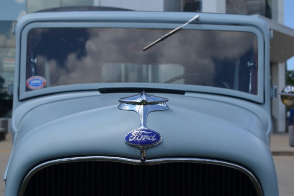 close up of blue oval ford logo on a classic hot rod