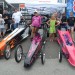 Children posing for pictures next to their Jr. Dragster race cars thumbnail