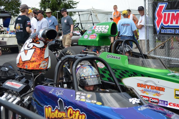 dragsters in staging lanes of an NHRA national event