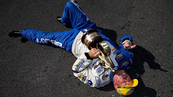 drag racer laying on ground to celebrate a win