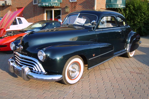 a black 1948 postwar Oldsmobile coupe