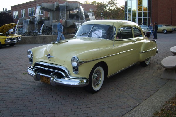 a yellow 1950 oldsmobile 88 coupe