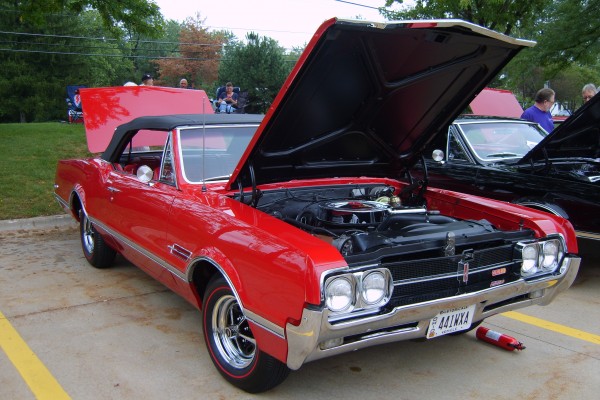 a red Oldsmobile 442 cutlass convertible