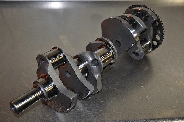 crankshaft for a v8 engine on a metal surface