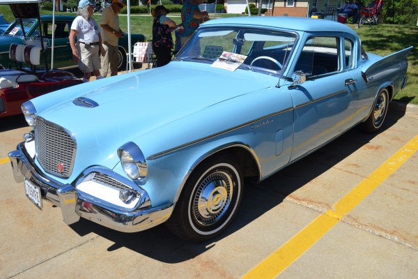 vintage blue studebaker coupe at a classic car show