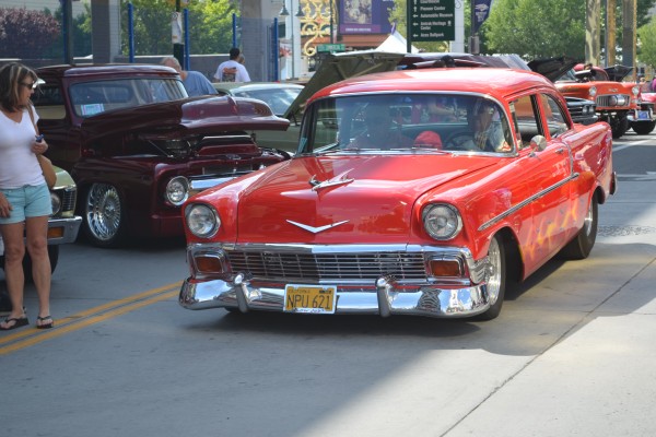 lowered 1956 chevy drag car in parade