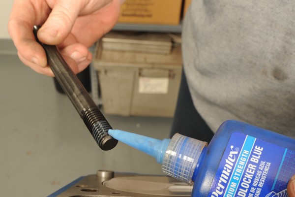 applying threadlocker to a cylinder head stud