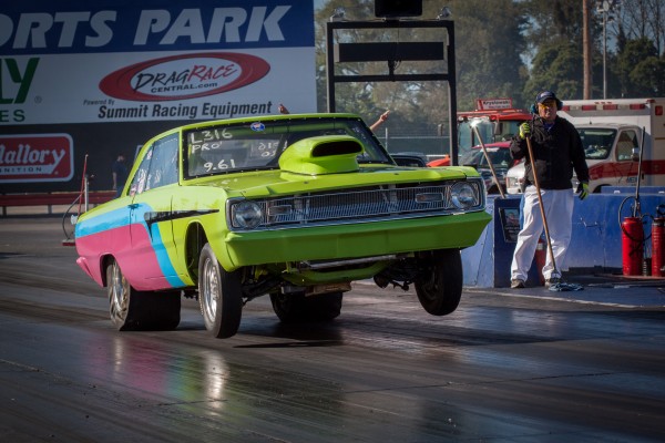 mopar modified drag car launching at dragstrip with wheelstand