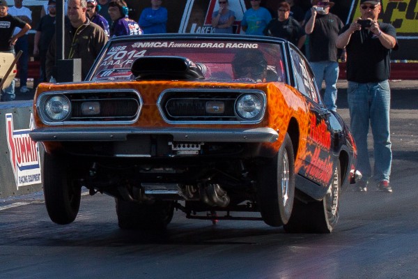 plymouth barracuda muscle car launching at a drag race track