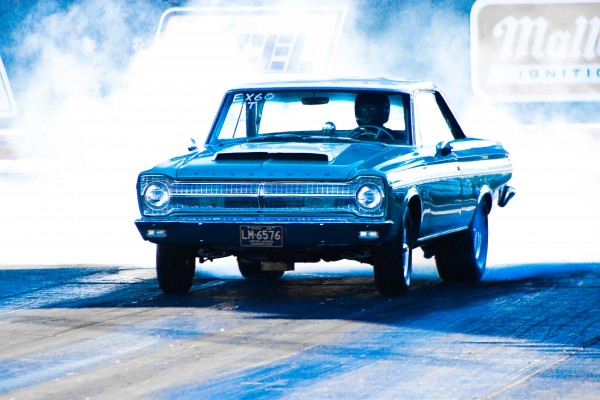 vintage plymouth belvedere doing a burnout at dragstrip