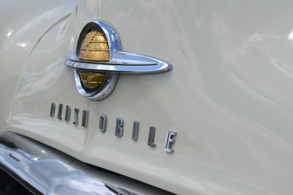 close up of ringed globe emblem on a 1959 Oldsmobile 88 sedan delivery wagon