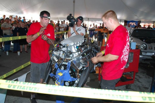 men rebuilding a GM LS engine during a contest