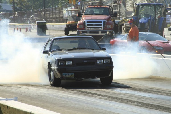 ls swapped fox body ford mustang doing a burnout