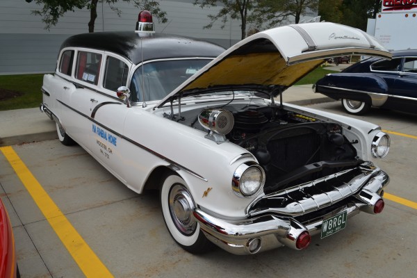 vintage 1956 Pontiac hearse in funeral home livery at a car show
