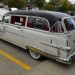 vintage 1956 Pontiac hearse in funeral home livery at a car show thumbnail