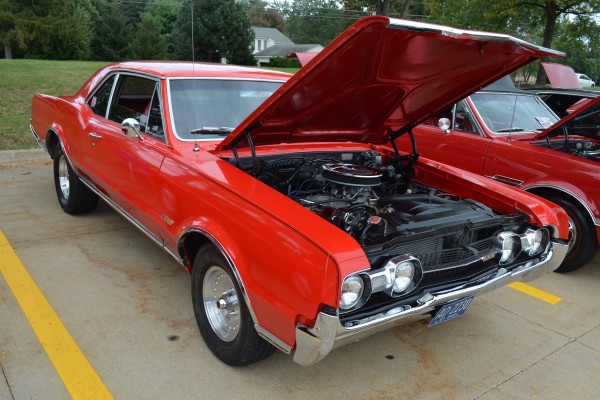 vintage olds cutlass 44 muscle car at a show