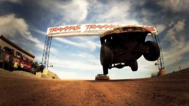 stadium truck leaping over camera on dirt track