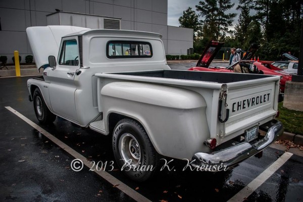 Rear tailgate view of a vintage silver chevy c10 pickup truck
