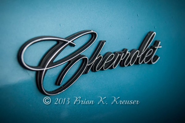 Close up of script Chevrolet emblem on fender of a classic car