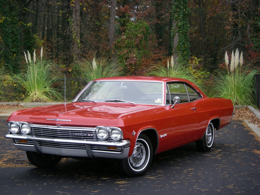 a red 1965 chevy impala super sport coupe