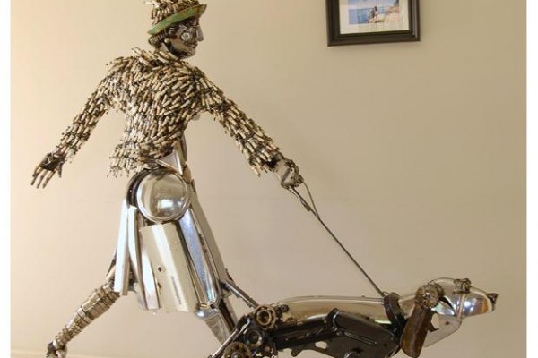 man walking a dog mechanical art sculpture