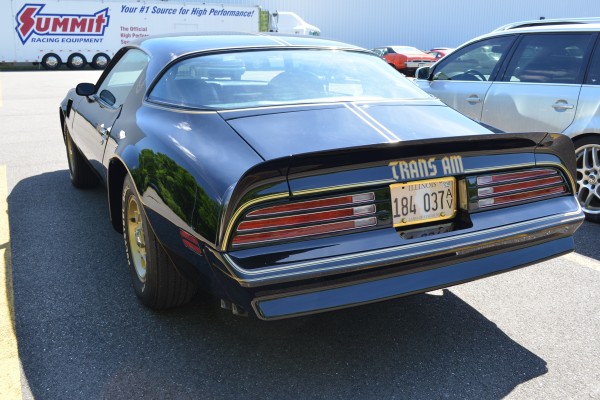 rear view of a black and gold 1976 pontiac trans am