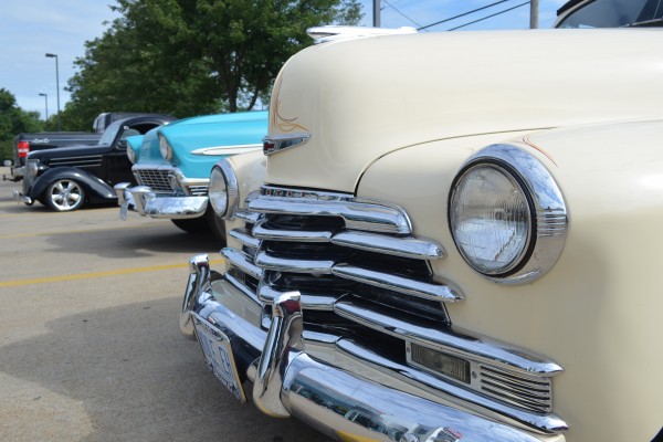 front ends of classic cars parked at Summit Racing in Akron