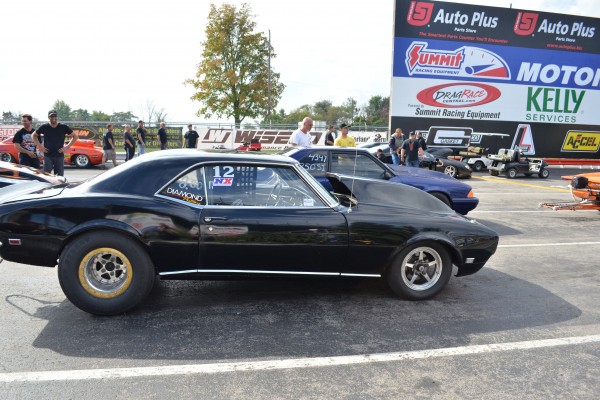 vintage drag cars and muscle cars in staging lanes at dragstrip