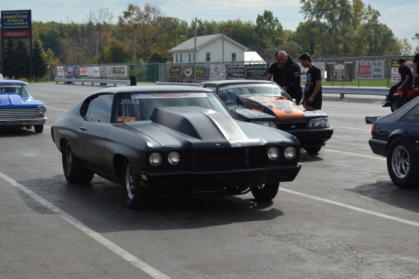 vintage drag cars and muscle cars in staging lanes at dragstrip