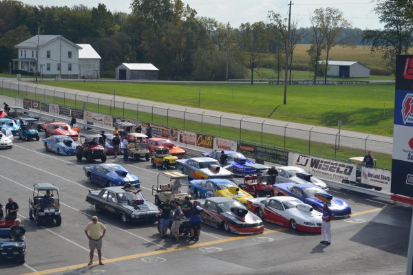 rows of drag race cars lining up for a race in staging lanes