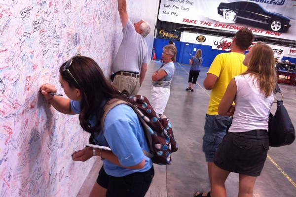 visitors signing wall at Carrol Shelby museum