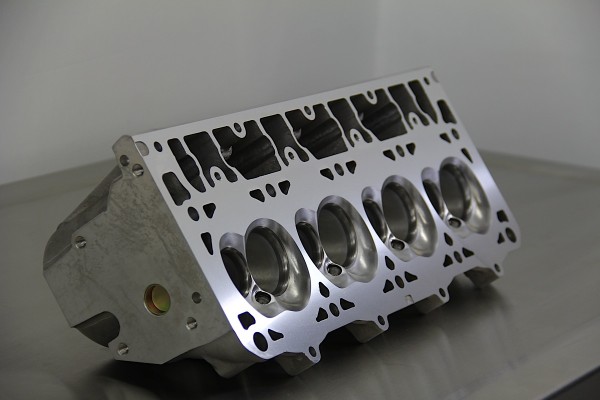a cylinder head resting on a metal work table