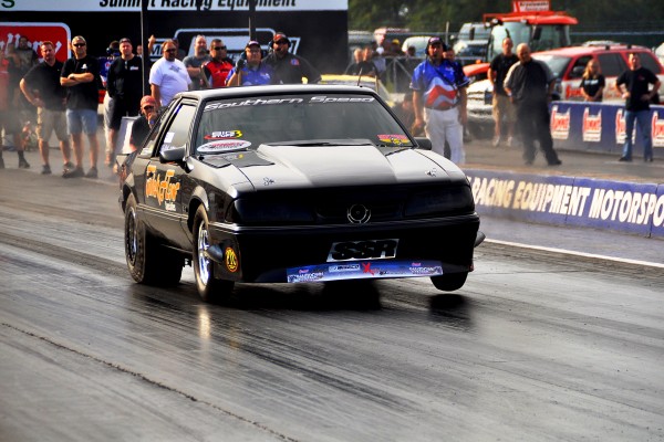 fox body ford mustang drag car in trick flow livery on track