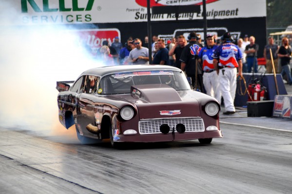 1955 chevy drag car doing a burnout prior to launch