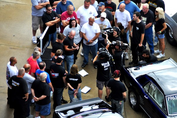 vintage muscle cars and drag racers in winner's circle