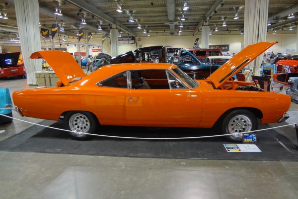 orange 1968 plymouth road runner at indoor car show