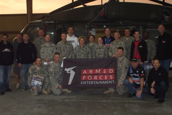 NHRA Drivers pose for a photo with military troops during overseas base visit