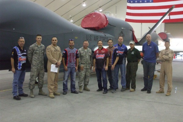 NHRA Race car drivers pose for photo with military troops stationed overseas
