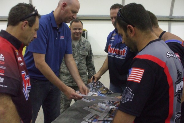 nhra drivers singing autographs for military troops stationed overseas