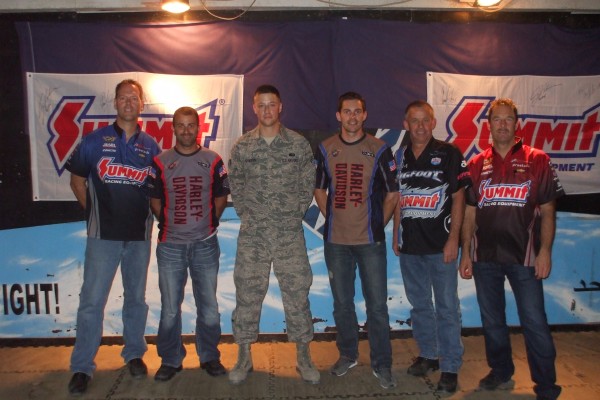 NHRA drivers pose for a photo with military troops stationed overseas