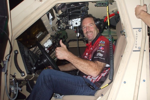 nhra driver in military vehicle during an overseas base visit