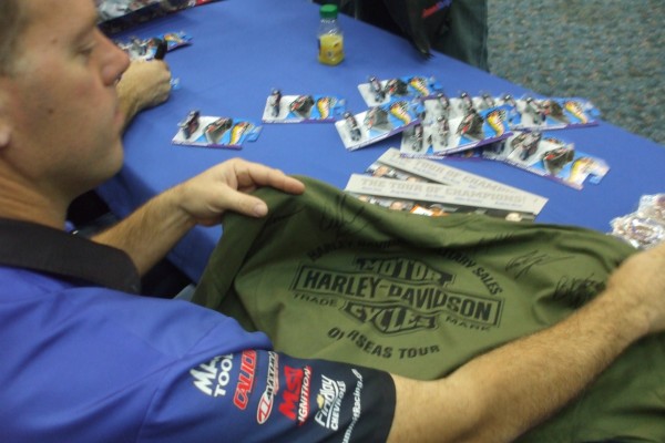Jason Line signing autographs for troops stationed overseas