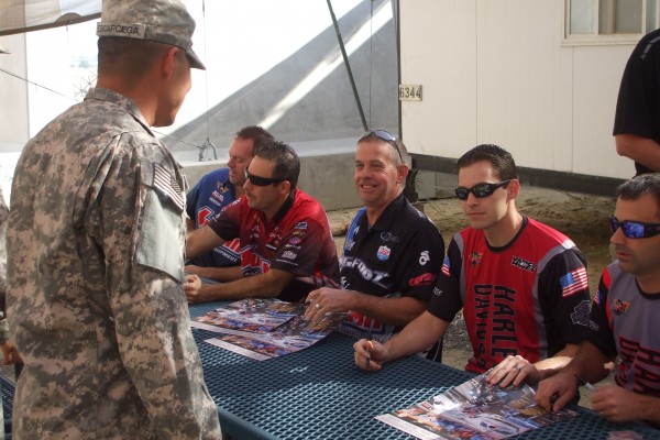 NHRA & Monster Truck Drivers signing autographs for troops stationed overseas