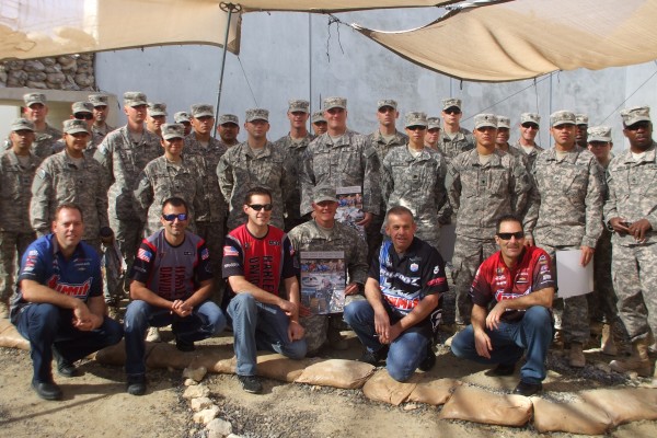 nhra and bigfoot drivers pose for photos with military troops stationed overseas