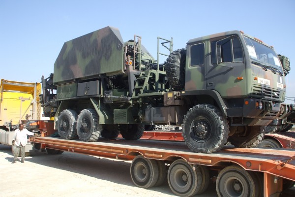 military truck on trailer for delivery to military base