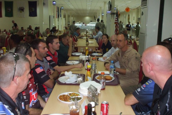 NHRA Drivers eating dinner with military troops stationed overseas
