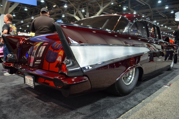 rear view of a custom 1957 chevy coupe on display at SEMA 2023