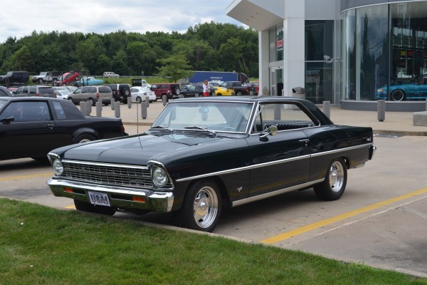 front and side view of a black 1967 Chevy II Nova with custom wheels