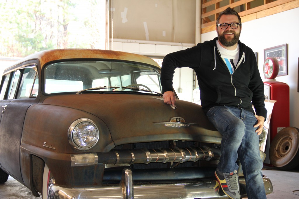 rutledge wood rests on his 1953 plymouth suburban wagon