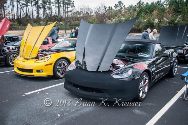 a pair of c6 corvettes at a car show